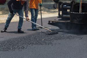 workers applying an asphalt overlay