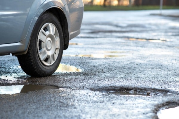 Car parked by a pothole