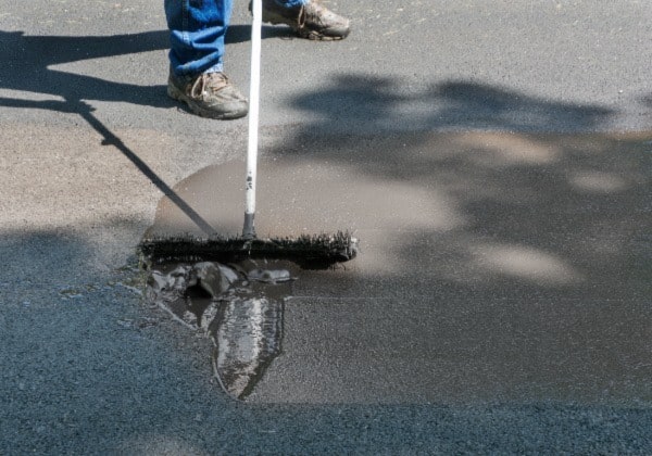 Image of person performing parking lot maintenance.