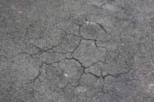 What Is Asphalt Raveling? How Can You Prevent It? - MCConnell & Associates  MCConnell & Associates