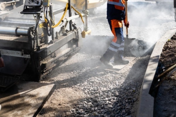 Person laying asphalt